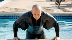 Climbing out of a pool wearing the LimpKenFin suit